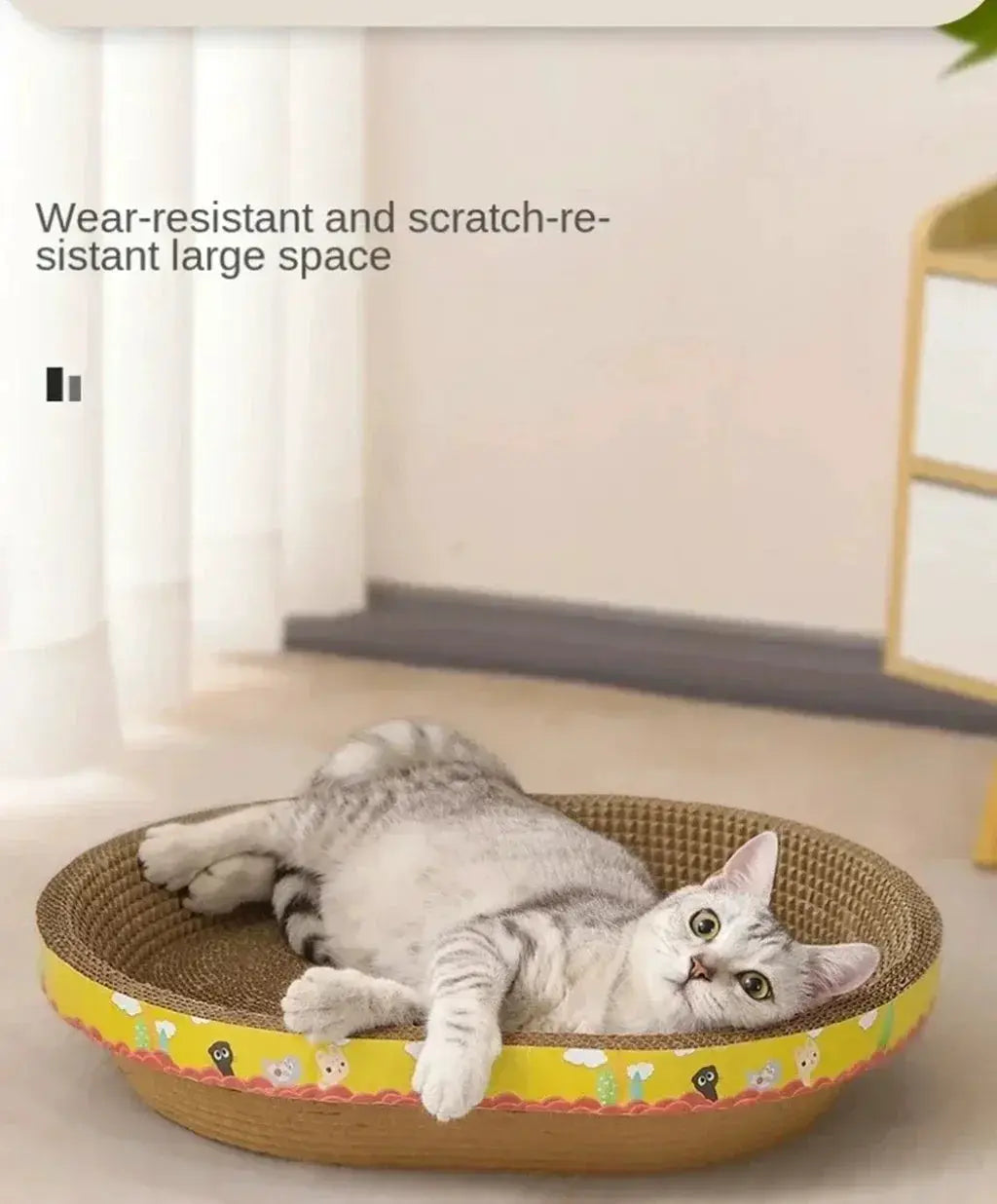 Cat scratching board, oval corrugated cardboard bed with a yellow cartoon-animal border, cat lounging inside.