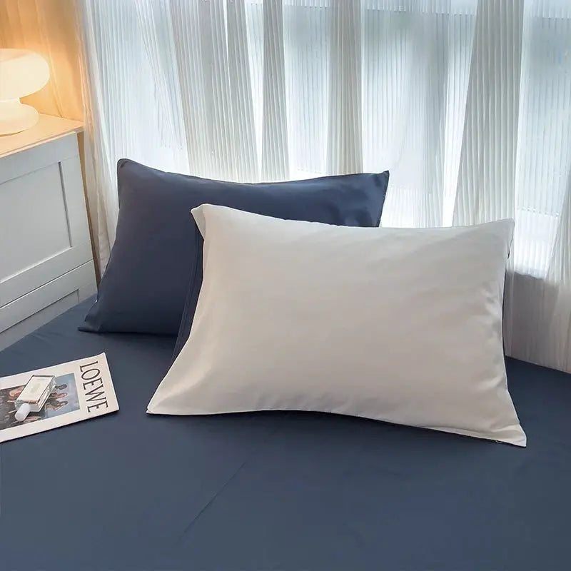 Simples Market 4-piece solid color brush fabric bed set with navy sheets and white pillowcases; two pillows shown
