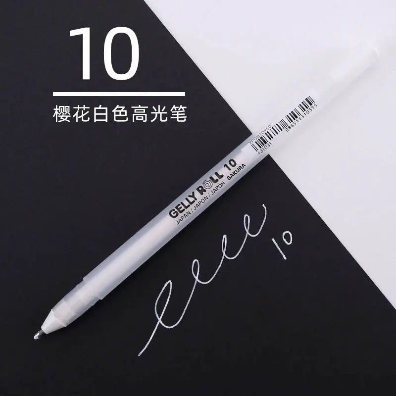 Sakura Gelly Roll gel pen in white ink with white barrel, shown on a black notebook