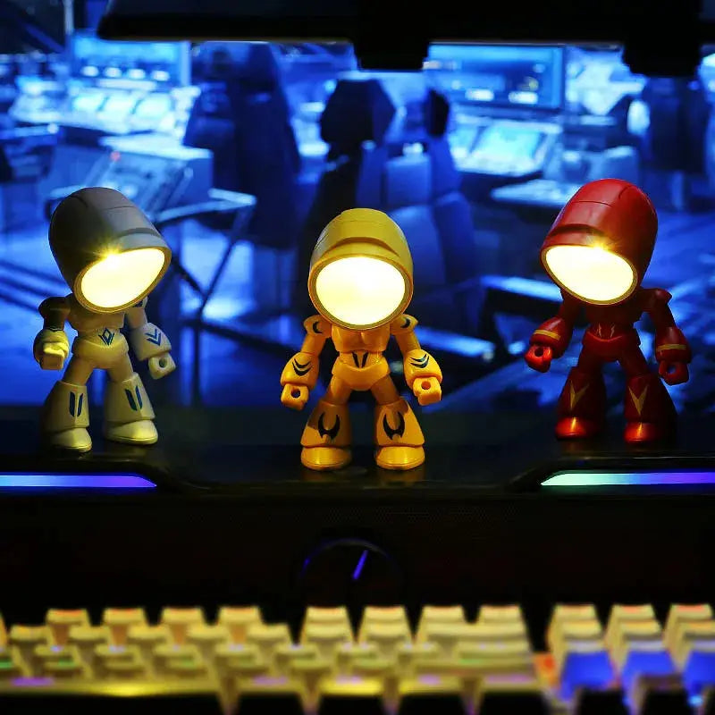 Mini Night Light LED cartoon hero police desk lamp trio in blue, yellow and red on a computer keyboard