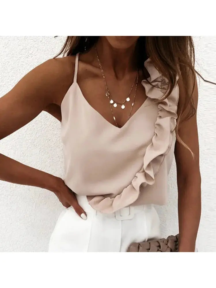 Beige sleeveless V-neck blouse with ruffle detail and spaghetti straps, styled with white trousers