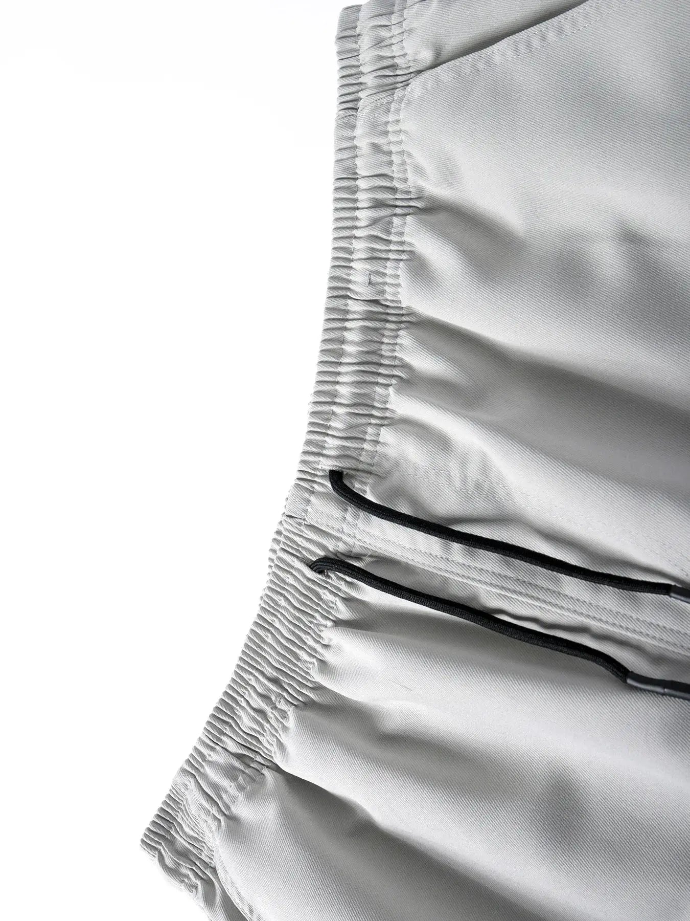 Men's casual cargo sweatpants waistband close-up in light gray with elastic and black drawstrings