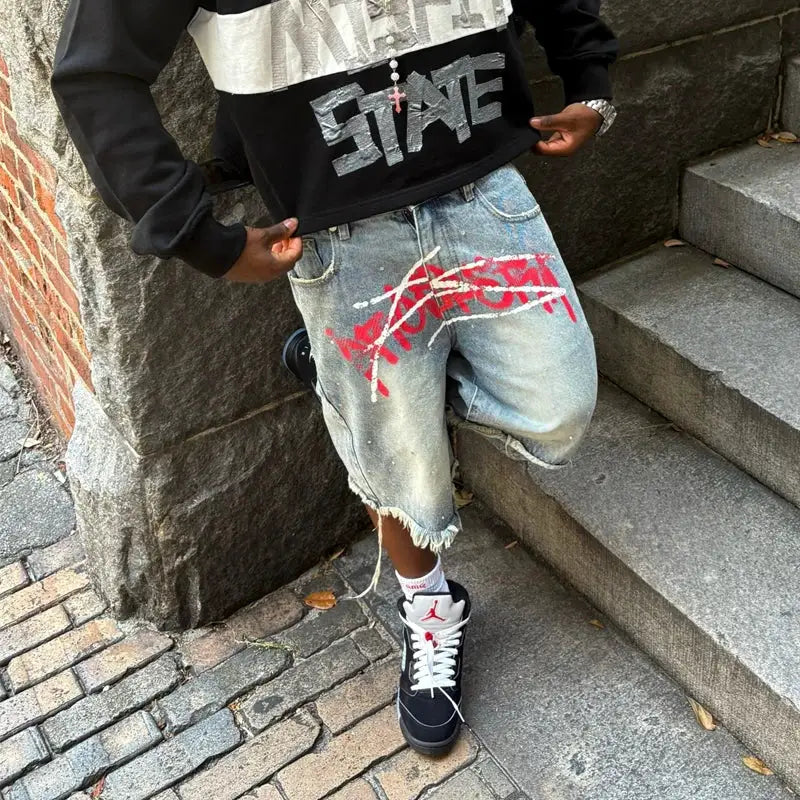 Simples Market Y2K graffiti jorts; distressed light denim with red spray print, unisex baggy shorts