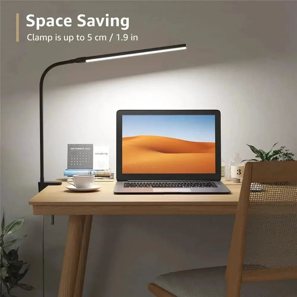LED desk lamp with gooseneck and clamp-on base in black lighting a laptop on a wooden desk