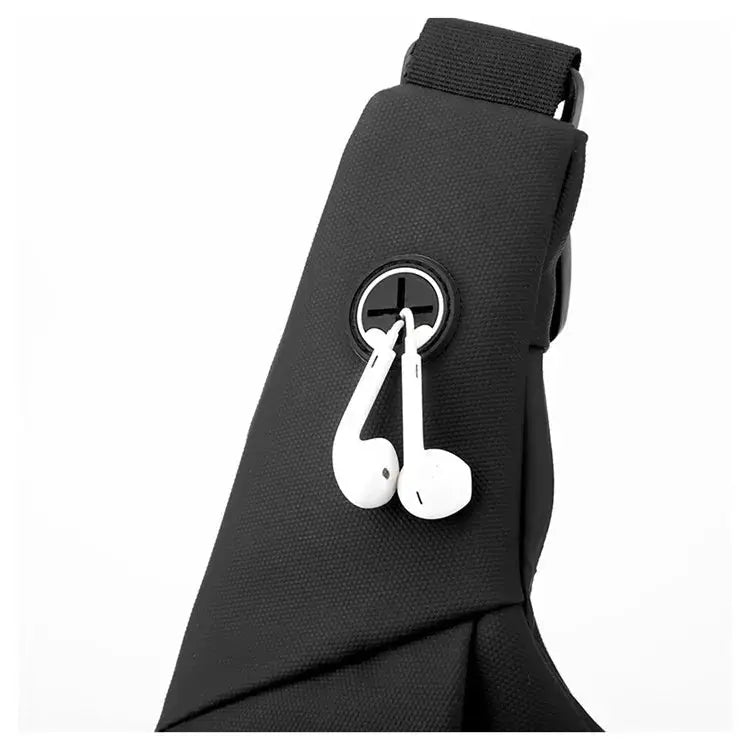 Sling chest bag, black, with white earphones attached