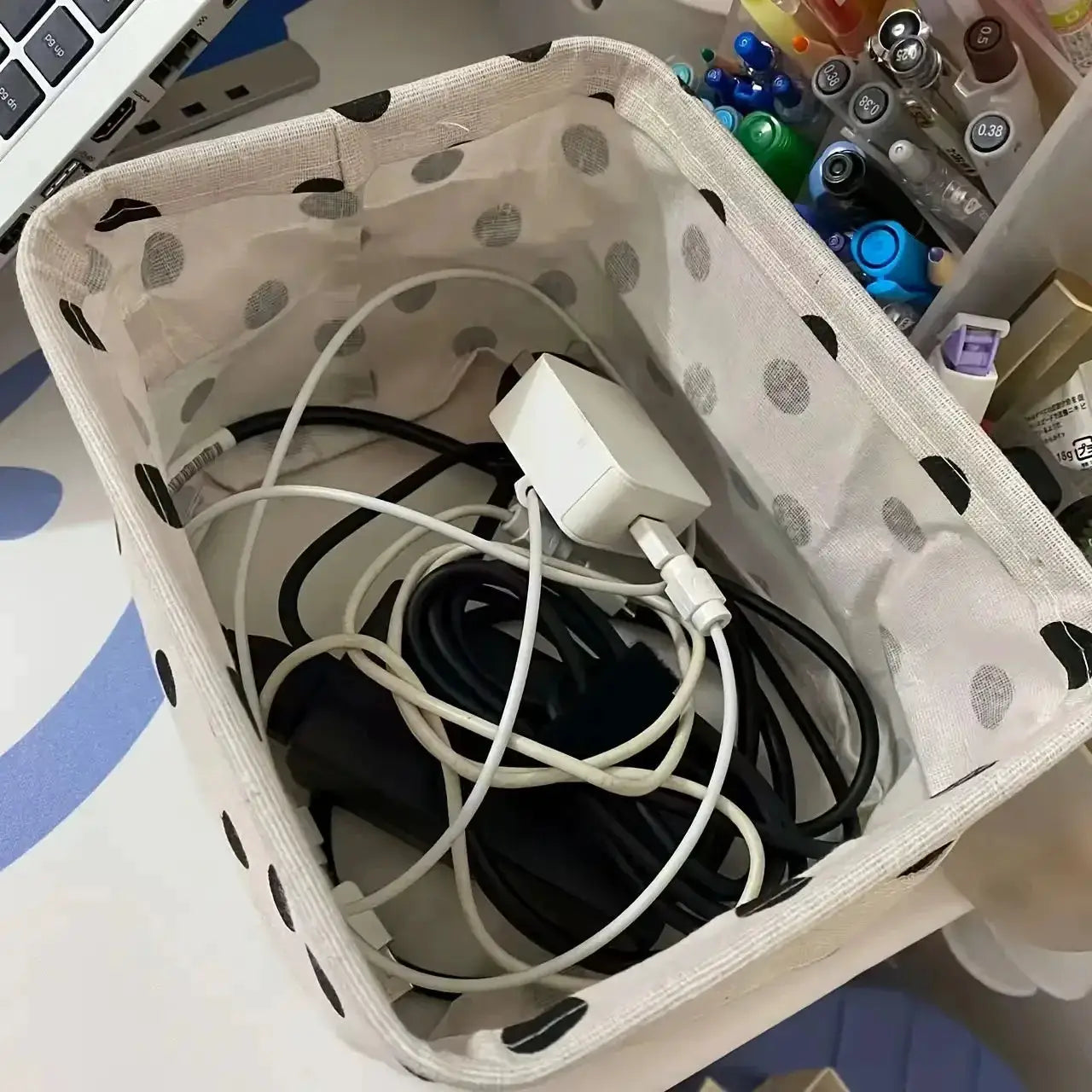 Small foldable canvas storage basket with handle, white with gray polka dots for desktop organization