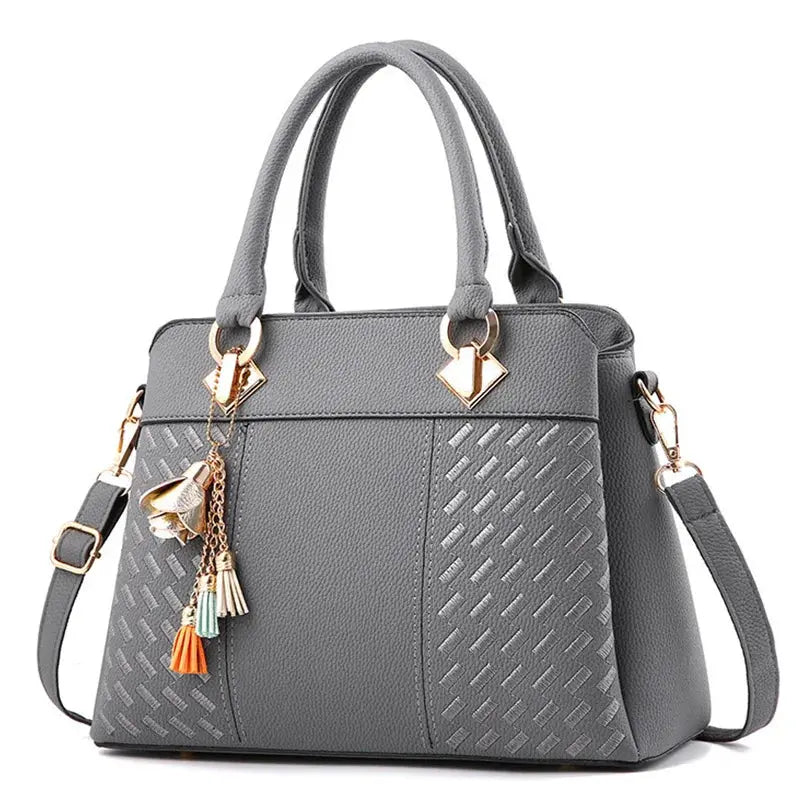 Tassel PU leather handbag in gray with top handles and detachable shoulder strap by Simples Market