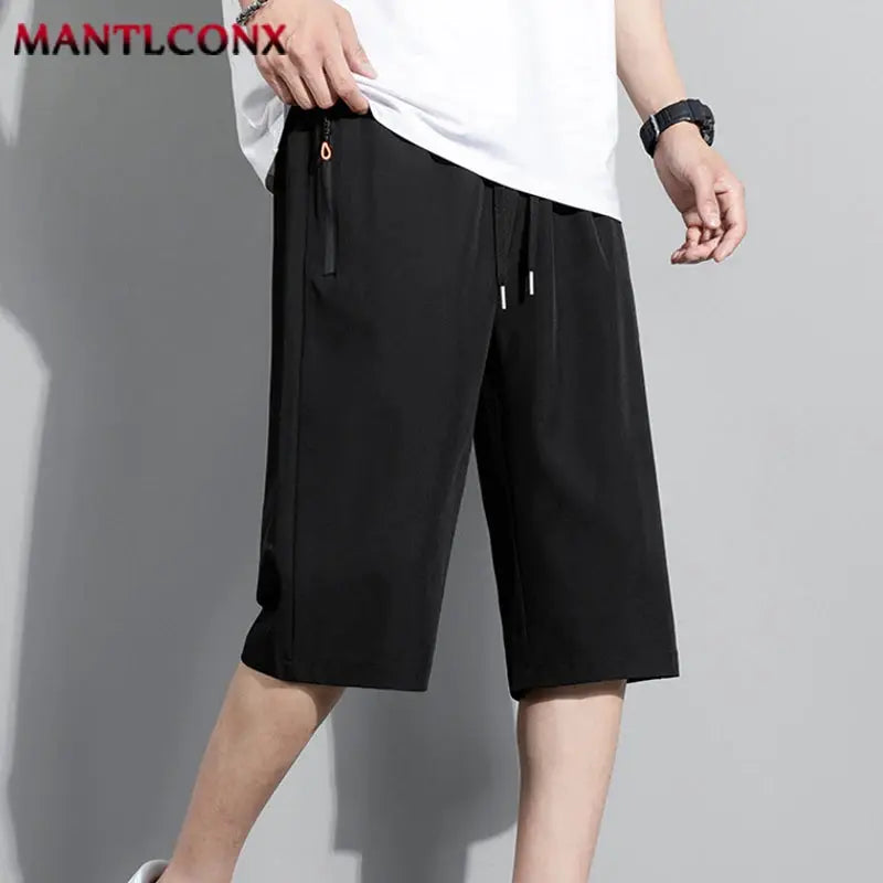 Men's black knee-length sports shorts with elastic waist and drawstring; MANTLCONX by Simples Market