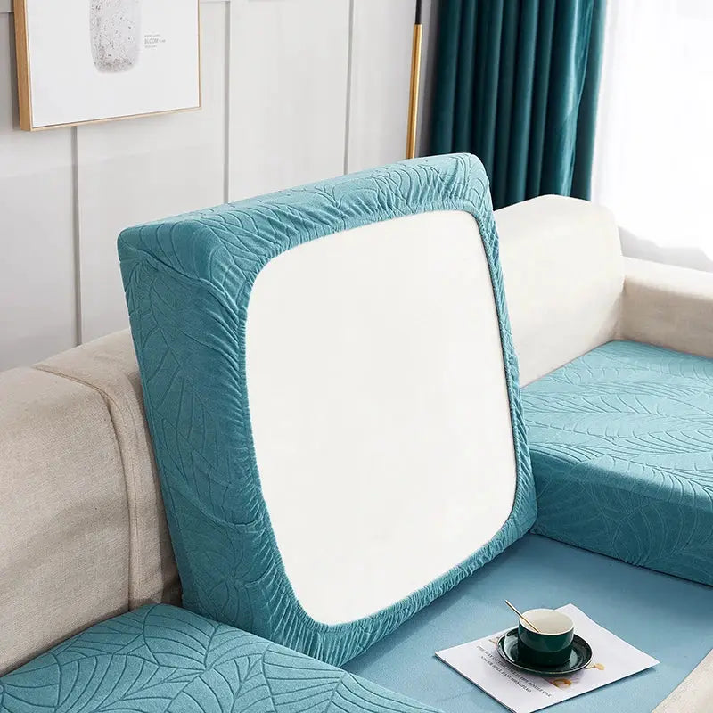 Simples Market waterproof stretch teal seat cushion slipcover with quilted leaf pattern on a sofa