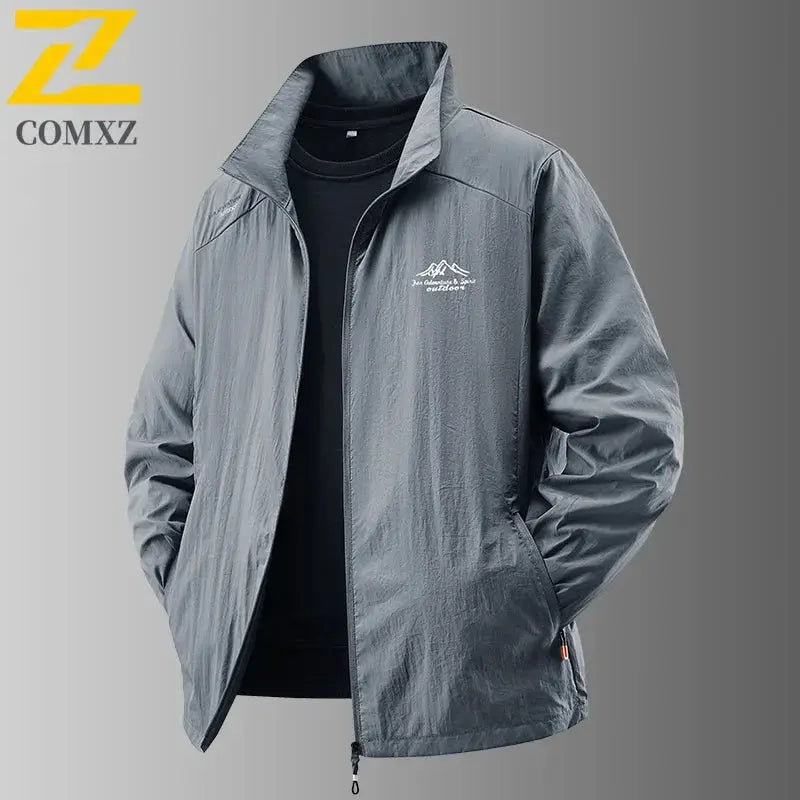 Men's ultralight sun protection jacket in grey with COMXZ logo, zip front, stand collar.
