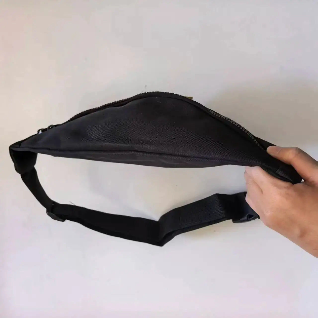 Black fanny pack waist bag by Simples Market with zipper closure and adjustable strap