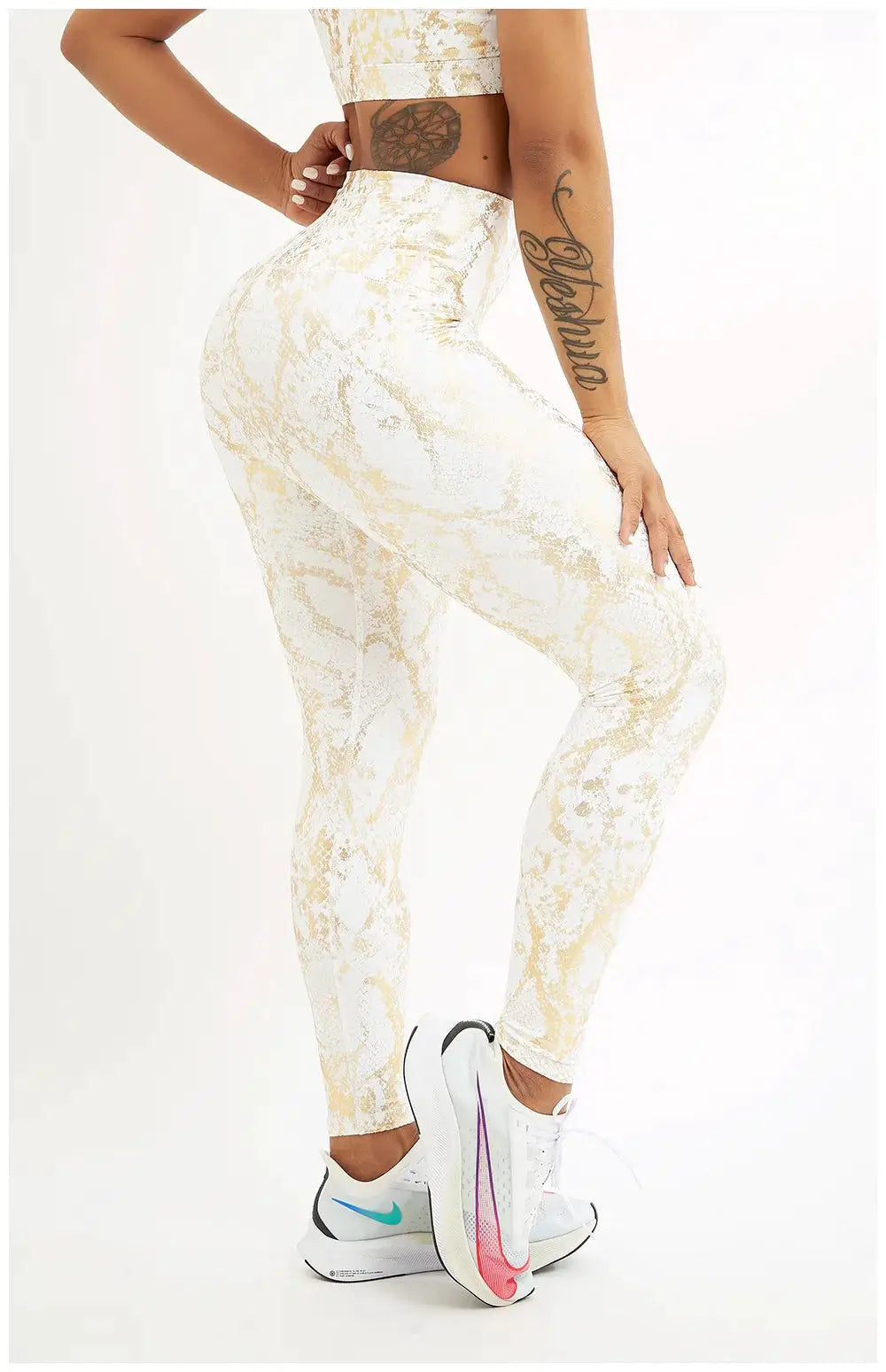 Snake print yoga pants by Simples Market; white with beige-gold pattern, high-waisted stretchy leggings