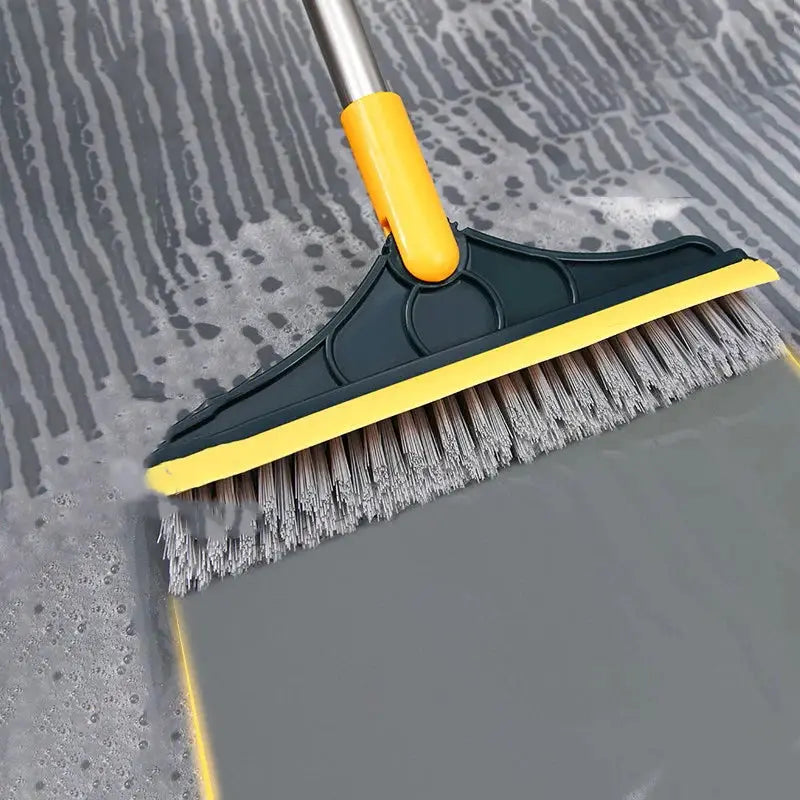 Bathroom floor cleaning brush with long yellow handle and gray bristles by Simples Market.