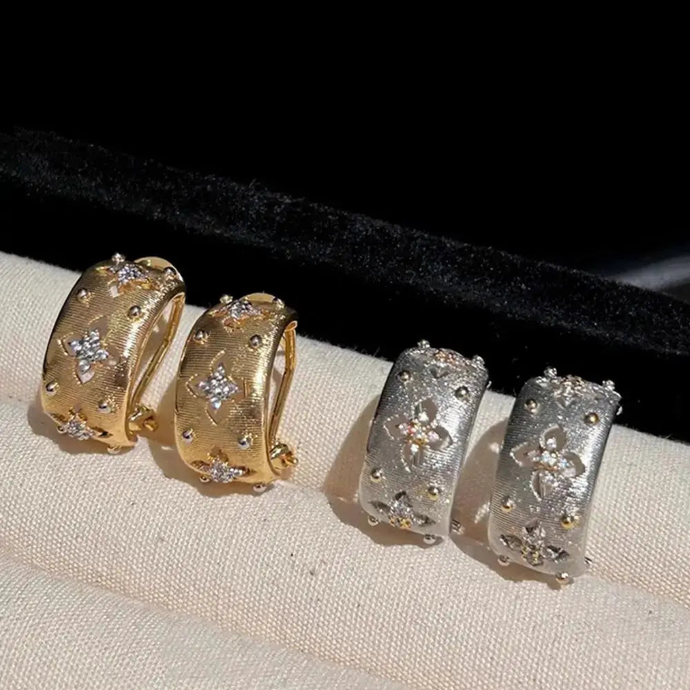 Hollow flower stud earrings set in gold and silver tones with zircon inlays by Simples Market, four pieces.