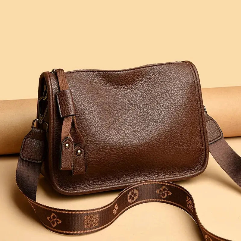 Brown genuine leather crossbody bag with tassel zipper pulls