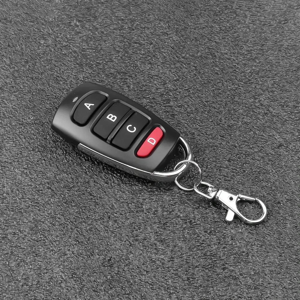 Simples Market wireless RF 433MHz remote key fob with four buttons A-D on black plastic, attached to a metal keychain.