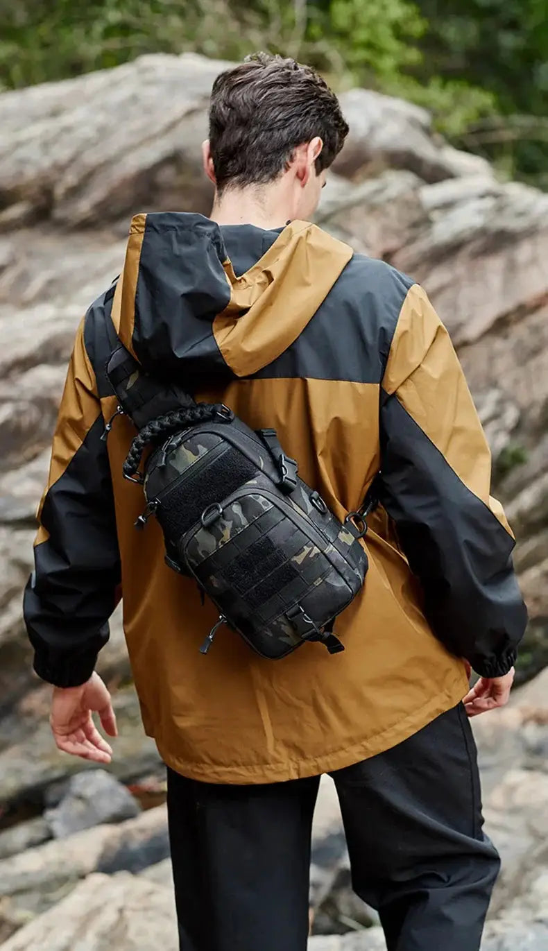Simples Market tactical chest bag with camo MOLLE sling worn across the back.