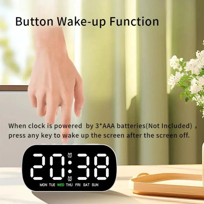 Digital LED alarm clock on a desk with black rounded case displaying time and weekday abbreviations