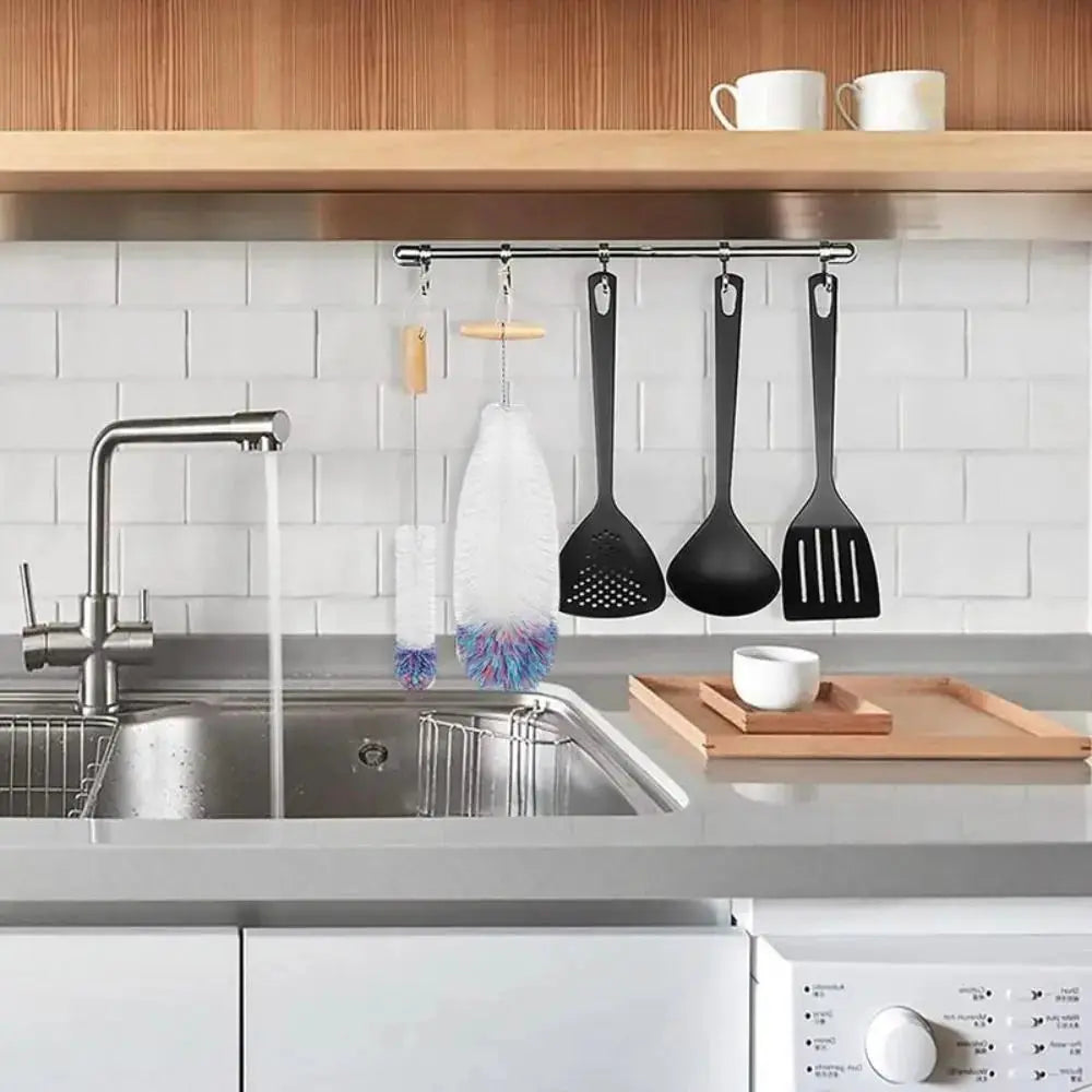 Durable SodaStream bottle brush with beechwood handle and other kitchen cleaning tools hanging on a rack