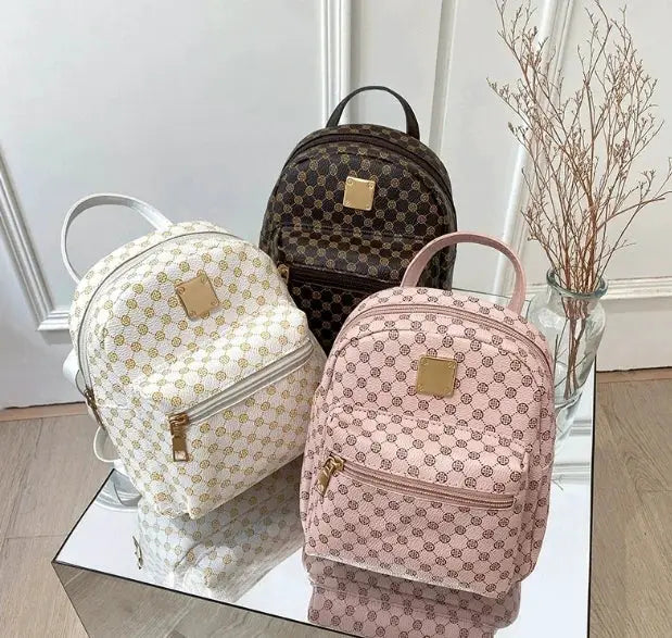Backpacks by Simples Market; three women's fashion school backpacks in white with gold pattern, pink, and brown.