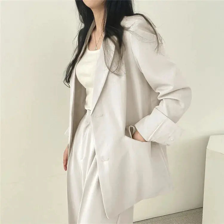 Women's 2-piece blazer and pants set in light beige; oversized blazer with matching pants.