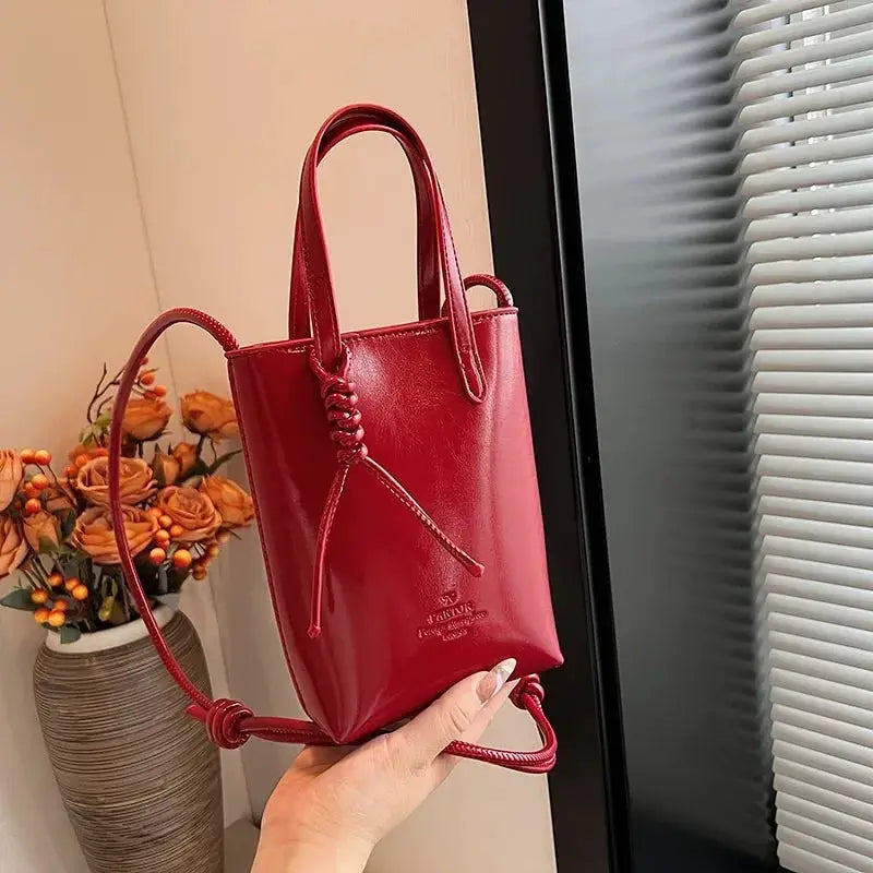 PU leather mini crossbody bag, red, with top handles, long strap, and bead-embellished cord