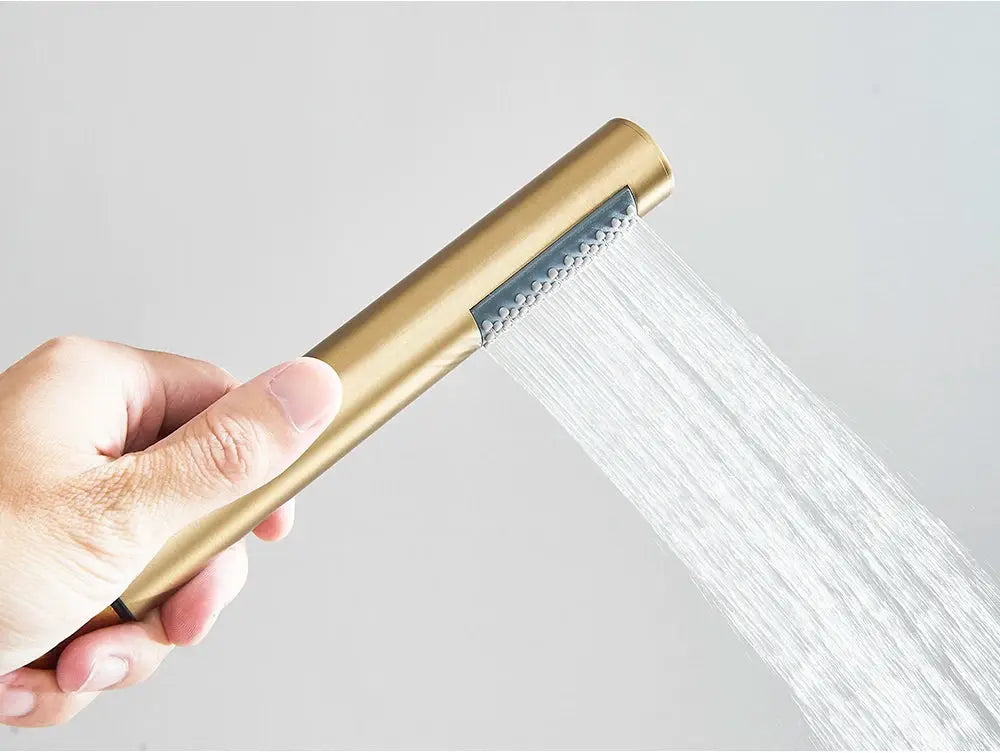 Brushed gold handheld shower head being held with water spray; single-function design