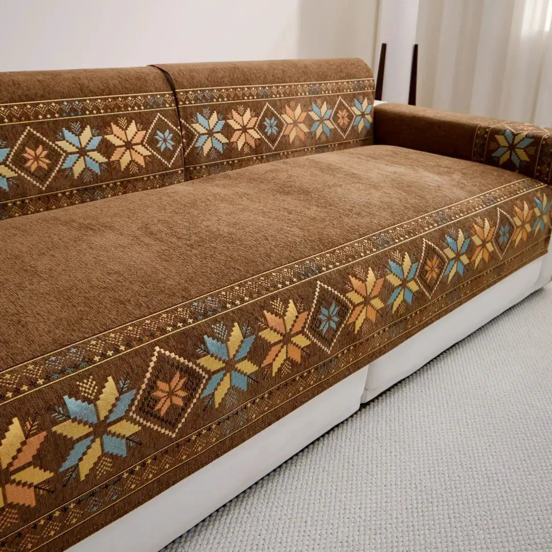 Sofa cover in brown bohemian jacquard chenille with blue-tan geometric trim