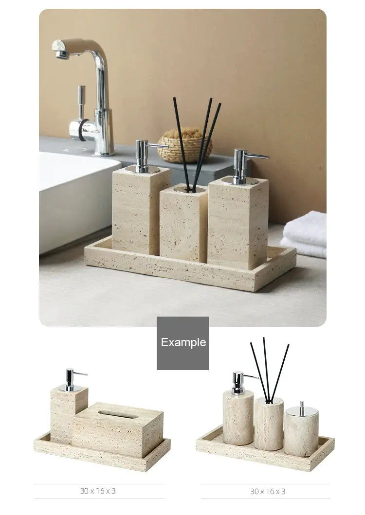Beige travertine bathroom accessories set with soap dispenser, soap dish, and reed diffuser on a vanity tray