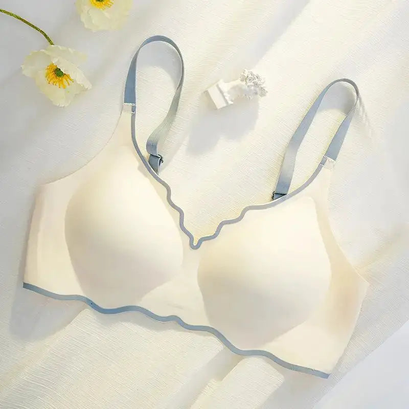 Cream women's push-up bra with blue-gray adjustable straps and wavy trim along neckline and hem for comfortable fit