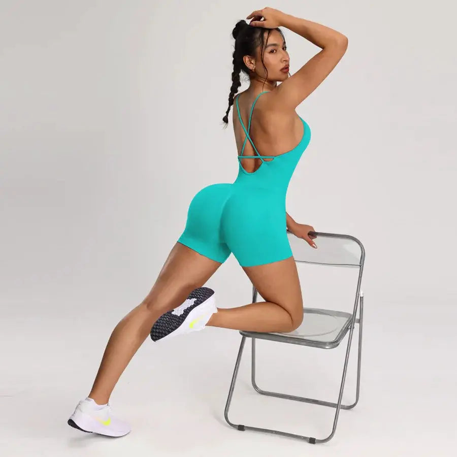 Backless teal bodysuit romper with criss-cross back straps and short shorts by Simples Market