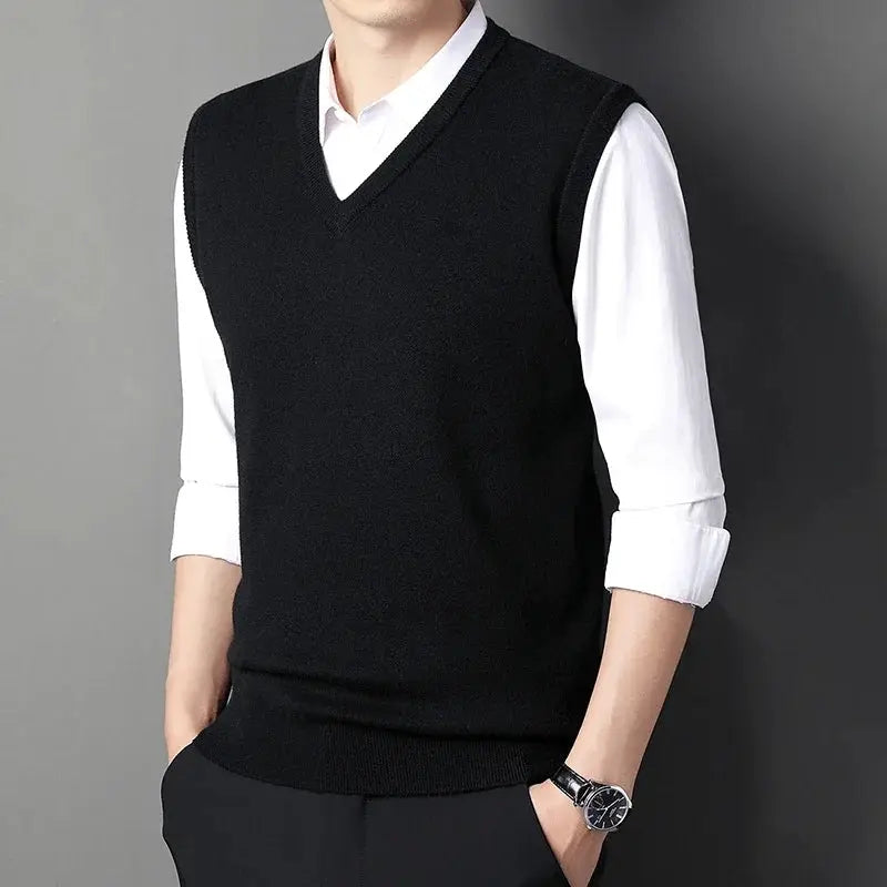 Men's black V-neck knitted vest, solid color, worn over white shirt.