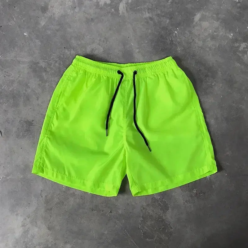 Men's neon green swim shorts with black drawstring, boardshort style
