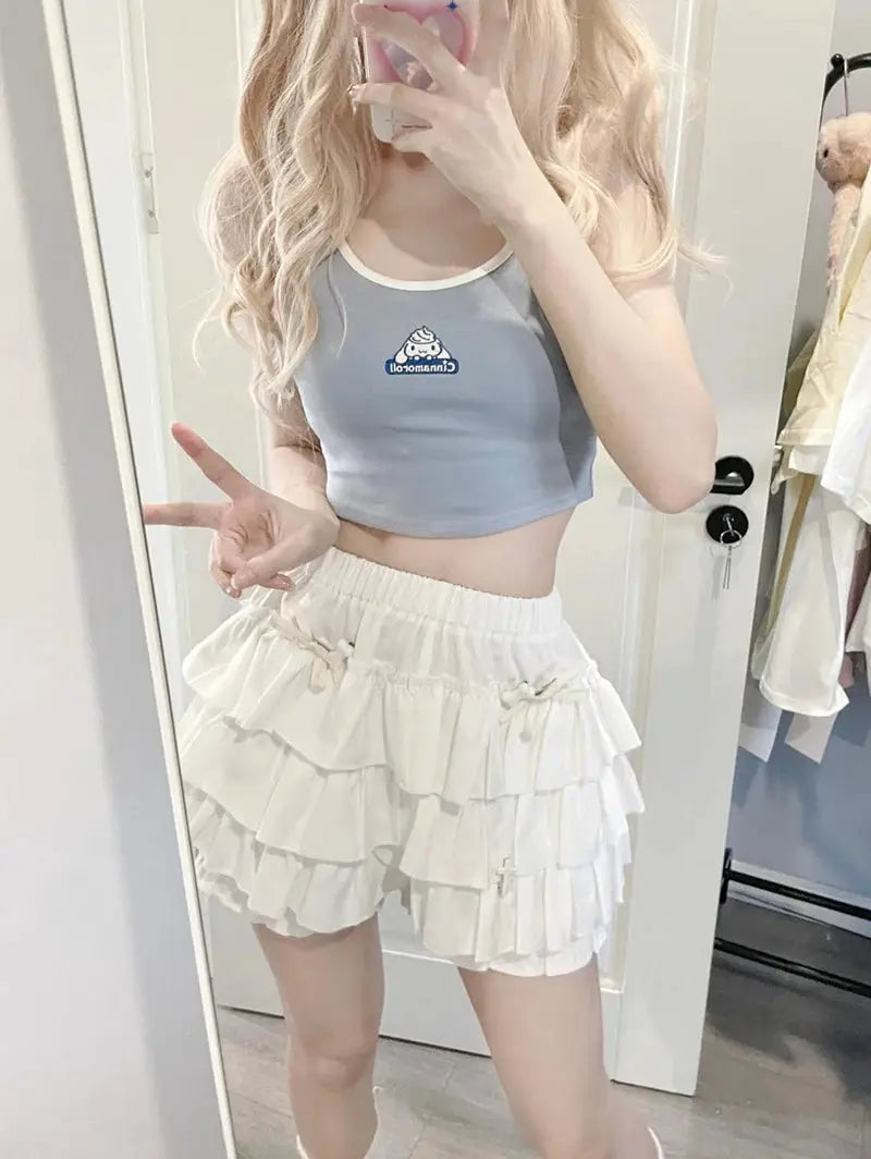 Mini skirt with white tiered ruffles; two-piece set shown with light blue cropped top.