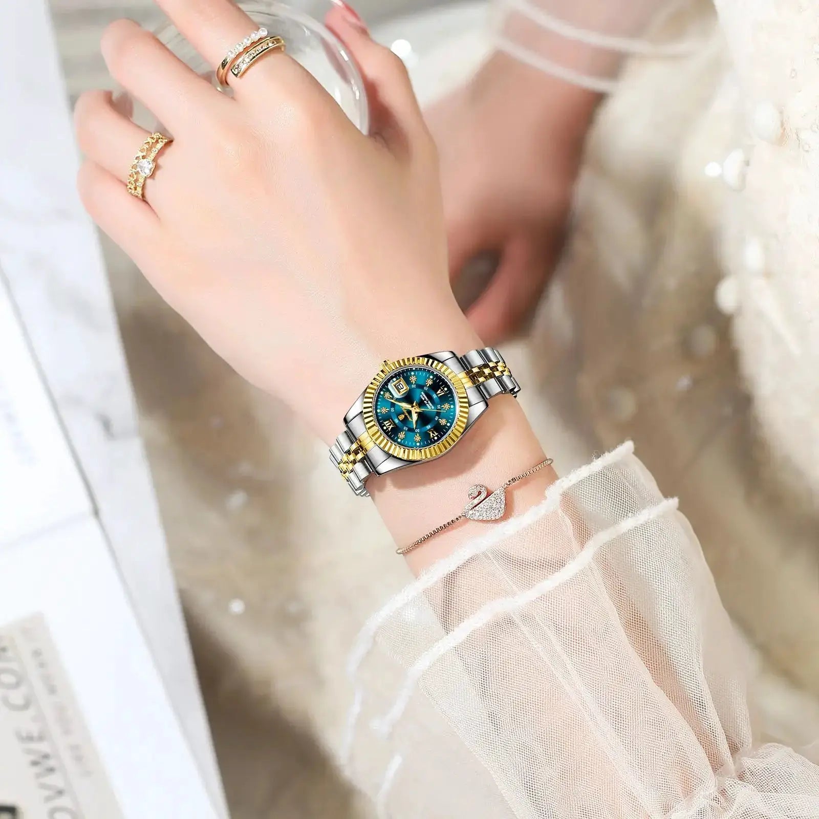 POEDAGAR luxury women's watch with a two-tone stainless steel bracelet, blue dial, and date window