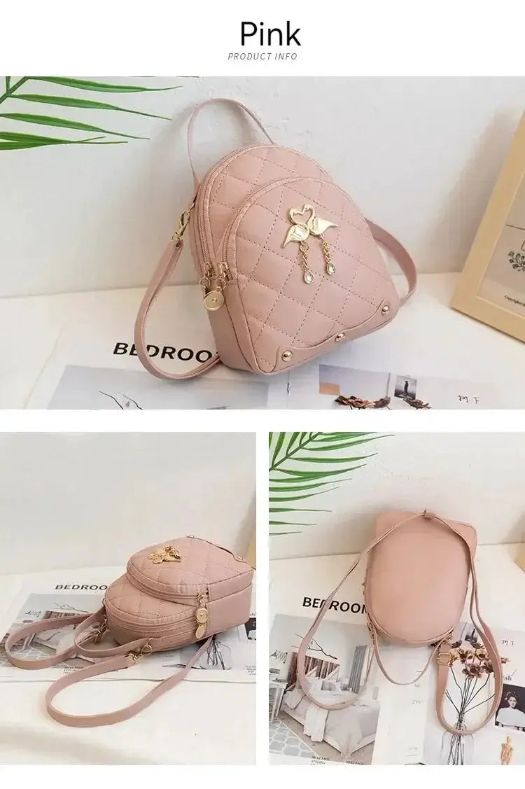 Mini pink quilted backpack with gold-tone hardware and floral charm.