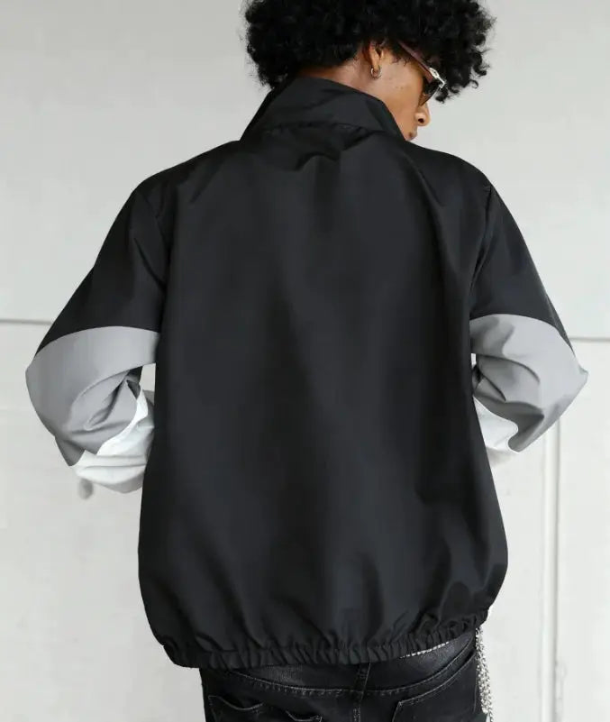 Men's color-blocked lightweight jacket with gray sleeve panels and elastic hem