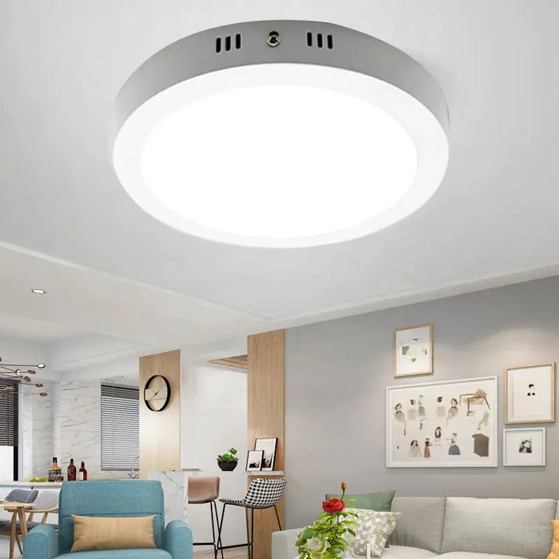 Led ceiling lamp round ultra-thin panel with white diffuser and gray trim, mounted on living room ceiling.
