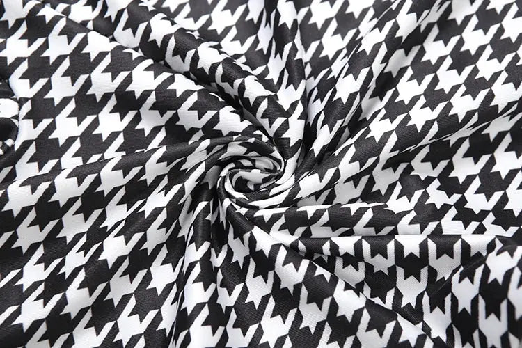 Black and white houndstooth fabric swatch with swirling pattern