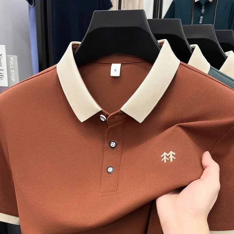 Short sleeve polo shirt in rust with cream collar, three-button placket, small embroidered emblem on chest