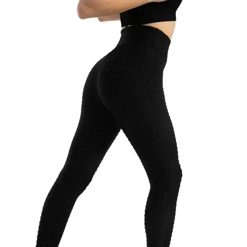 Women's high-waist bubble leggings, seamless black yoga gym pants with textured stretchy fabric.
