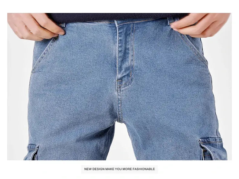Men's blue denim cargo pants with multiple pockets and front zipper fly, casual streetwear style.