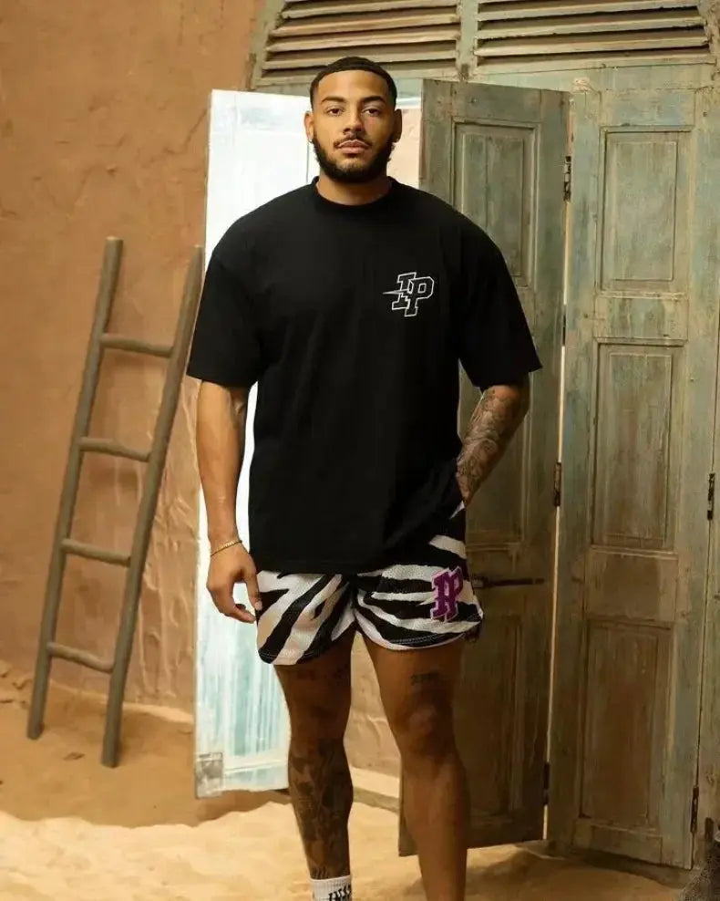 Men's IP Trend quick-dry shorts in black-and-white zebra print, paired with a black tee
