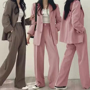 Three women's 2-piece blazer pant sets in taupe and pink