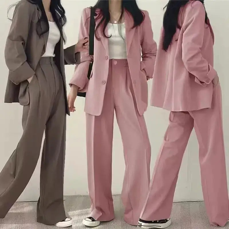 Three women's 2-piece blazer pant sets in taupe and pink