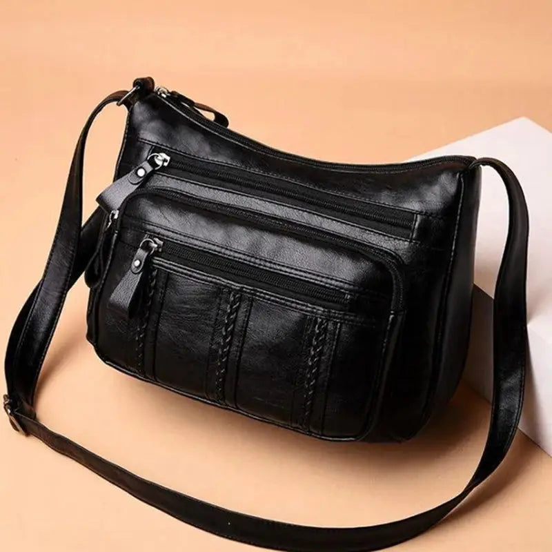 Women's PU leather crossbody bag with multilayered pockets in black and a shoulder strap