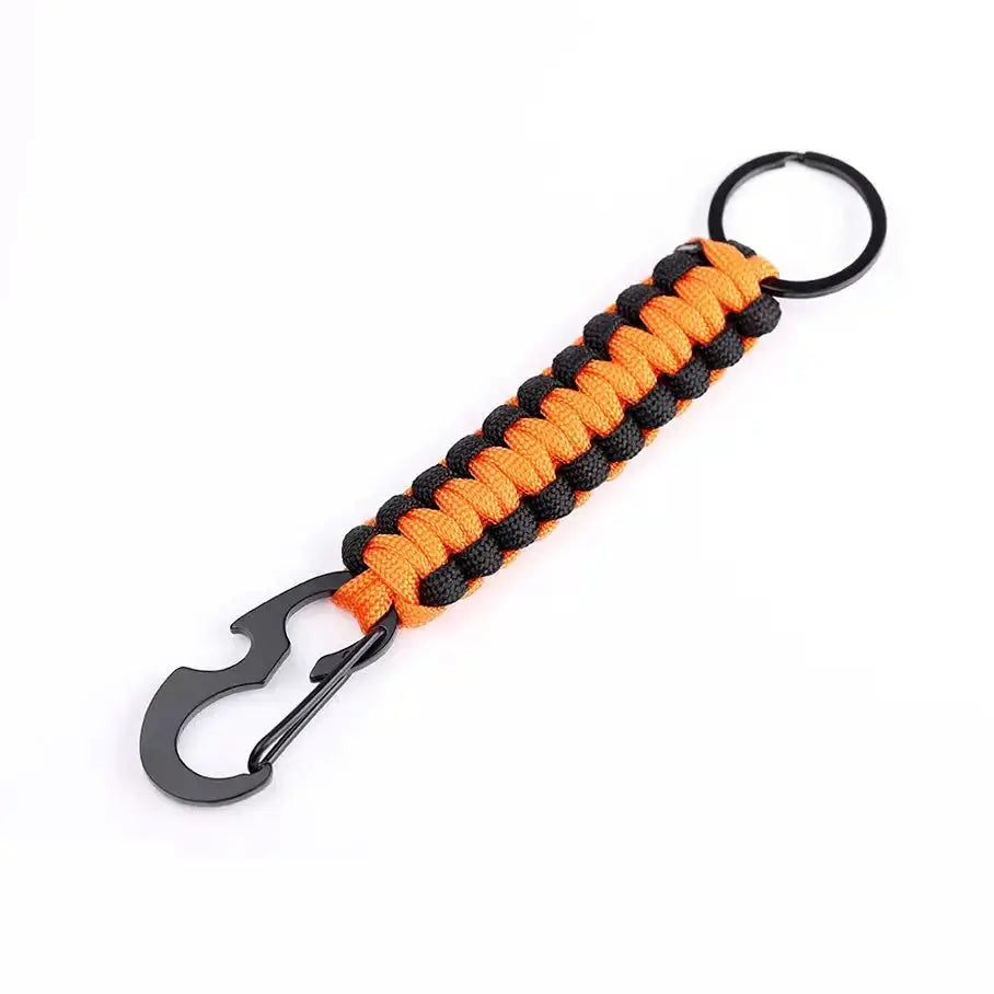 Paracord keychain with orange and black braided rope, featuring a metal bottle opener and a metal key ring