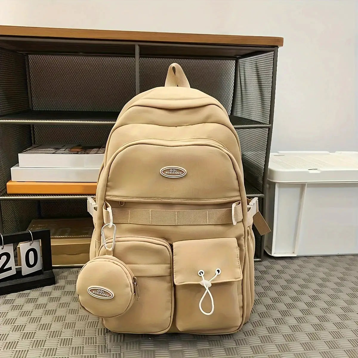 Simple Large Capacity Sports Travel Backpack beige with multiple pockets and an attached round pouch
