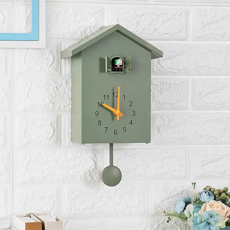 Cuckoo quartz wall clock by Simples Market; green birdhouse style with orange hands and pendulum