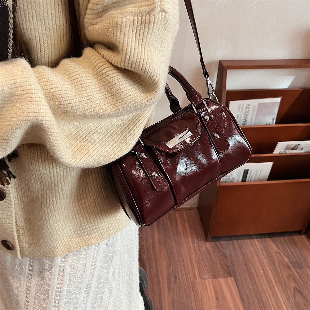 Burgundy mini top-handle bag by Simples Market in glossy patent PU leather